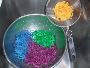 Dyed pasta chillin' in the strainer.