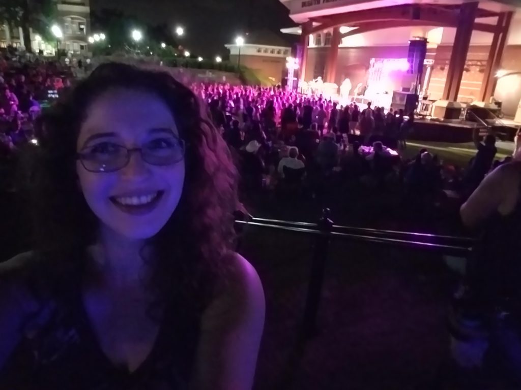 Angela with concert in the background